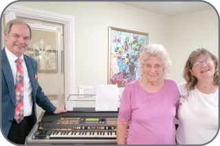 Michael and Carole with a Resident in the centre